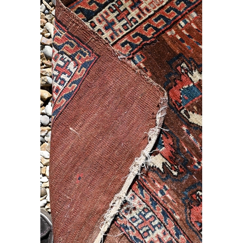 673 - An small antique Turkoman rug, 122 cm x 78 cm to/w a Turkoman bag face, 97 cm x 84 cm and a camel gr... 