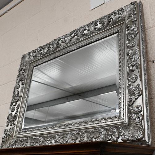 677 - A large Victorian style silver framed bevel edged mirror, 122 cm x 92 cm