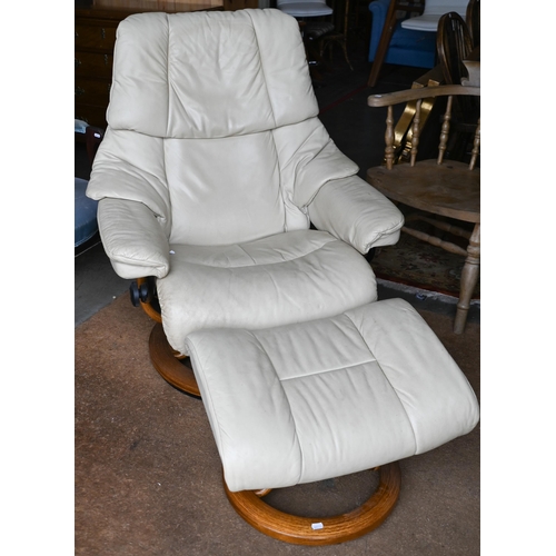 686 - An Ekornes Stressless cream leather reclining armchair amd matching footstool, a/f