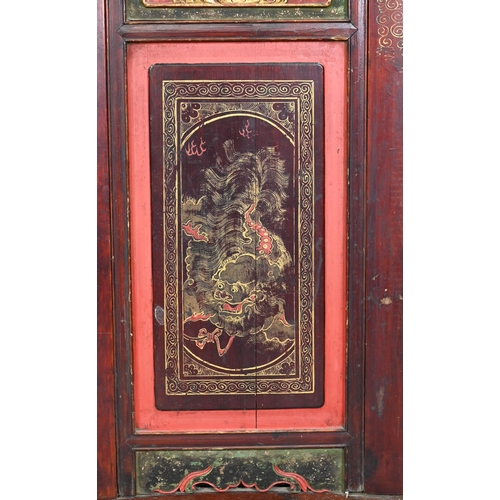 320A - A 19th century Chinese red and black lacquered three section wedding bed panel decoratively carved a... 