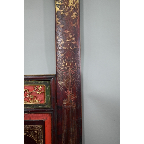 320A - A 19th century Chinese red and black lacquered three section wedding bed panel decoratively carved a... 