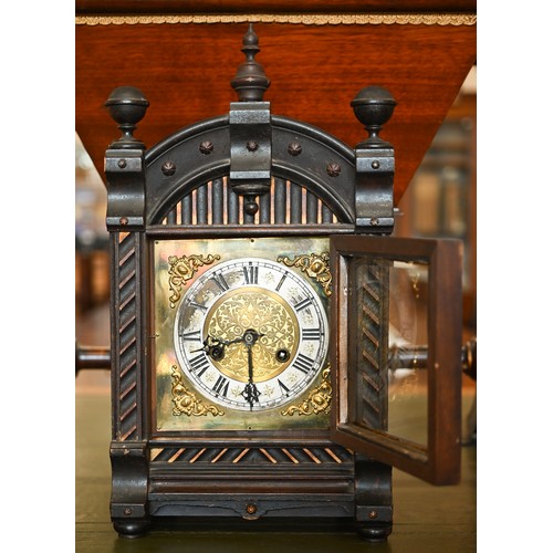 550 - An early 20th century German stained pine mantel clock, glazed door enclosing the brass and silvered... 