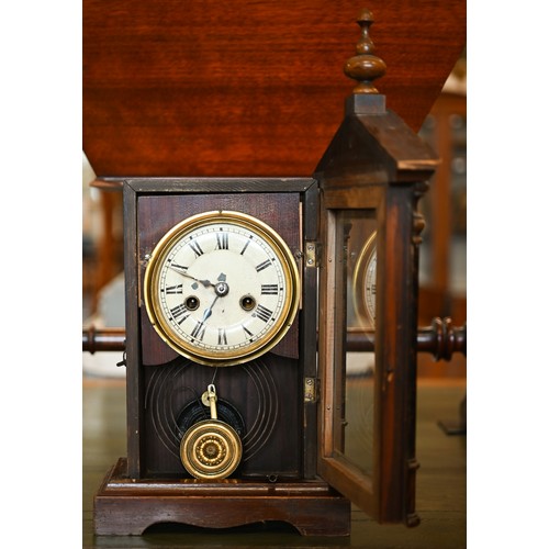 550 - An early 20th century German stained pine mantel clock, glazed door enclosing the brass and silvered... 