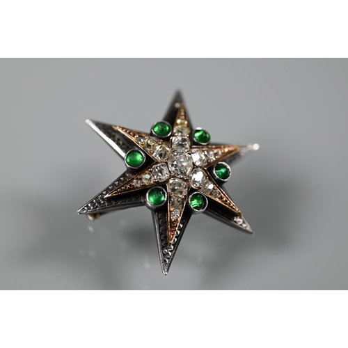 289 - A Victorian diamond and emerald star-shaped brooch, the six point star gold set with mixed cut diamo... 