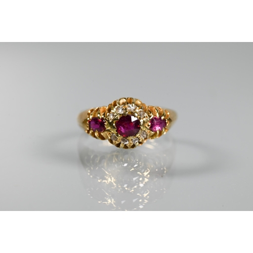 293 - An antique ruby and diamond cluster ring, the central oval ruby surrounded by small eight-cut diamon... 