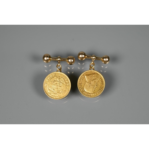 296 - A pair of South African 1/2 Pond coins dated 1895, set as cufflinks with 18ct chain and bar, approx ... 