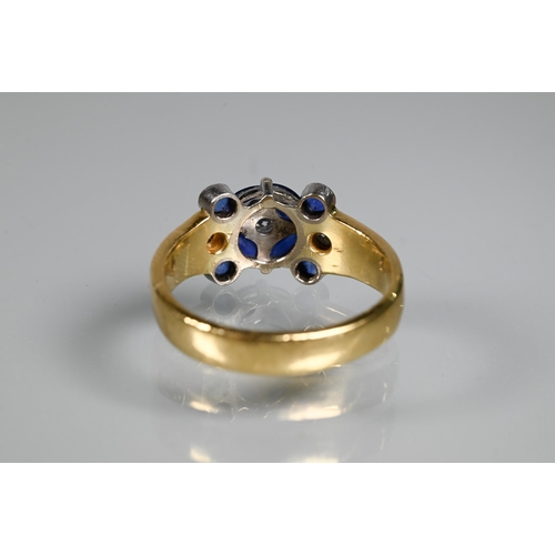 316 - An sapphire and diamond cluster ring, the central round brilliant cut diamond surrounded by four mar... 