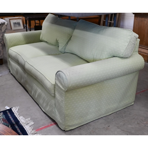 165 - A two seater scroll arm sofa, with patterned green fabric loose covers, 190 x 95 x 80 cm high