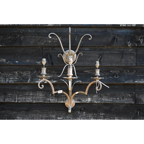 242 - A large scrolling metal three-sconce wall light, 65 cm high