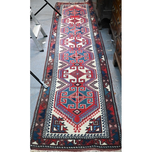 265 - A Continental Turkish runner, the camel ground with geometric pole design, 323 x 71 cm