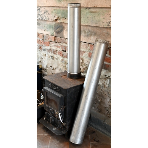 100 - A used cast iron wood burning stove, with two chimney sections - sold as removed