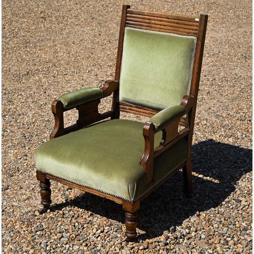 108 - An Edwardian green dralon upholstered walnut framed salon armchair, on castors