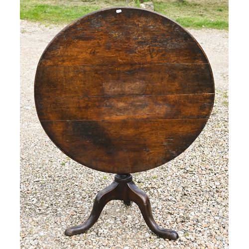 109 - A George III oak tilt top tripod table, 87 cm dia.