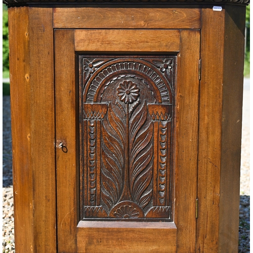 112 - An old oak hanging corner cupboard, with carved floral motif to the single door, 82 cm h