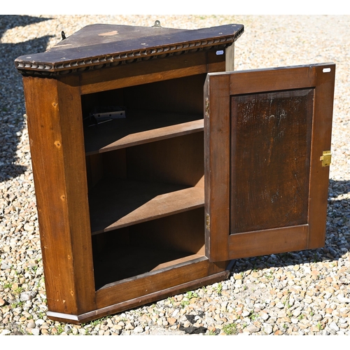 112 - An old oak hanging corner cupboard, with carved floral motif to the single door, 82 cm h