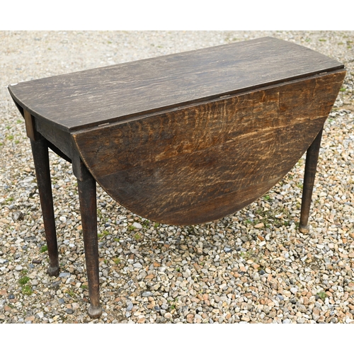 124 - A Georgian oak oval drop leaf gateleg supper table raised on paw feet, 115 cm x 47 cm (134 cm open) ... 