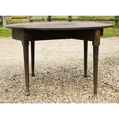 124 - A Georgian oak oval drop leaf gateleg supper table raised on paw feet, 115 cm x 47 cm (134 cm open) ... 