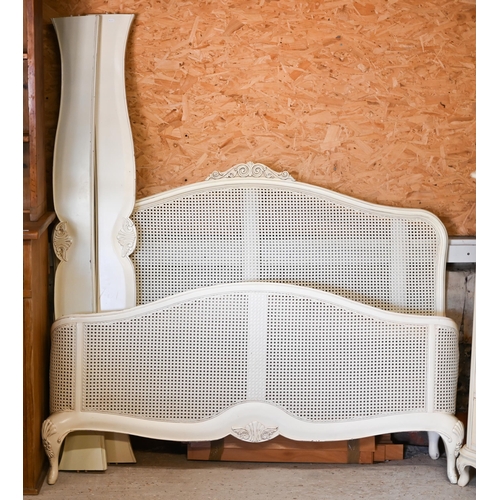 125 - Willis & Gambier - a part off-white finished bedroom suite, comprising a bergere ended kingsize ... 