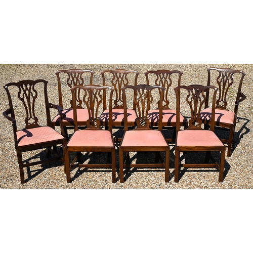 128 - A set of eight George III style mahogany ear-back dining chairs, with pink fabric seat pads comprisi... 