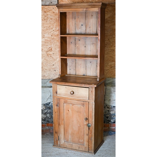 129 - An old pine narrow dresser, the planked open rack over a drawer and single cupboard, 69 cm x 46 cm x... 