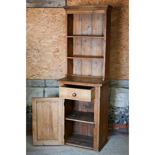 129 - An old pine narrow dresser, the planked open rack over a drawer and single cupboard, 69 cm x 46 cm x... 