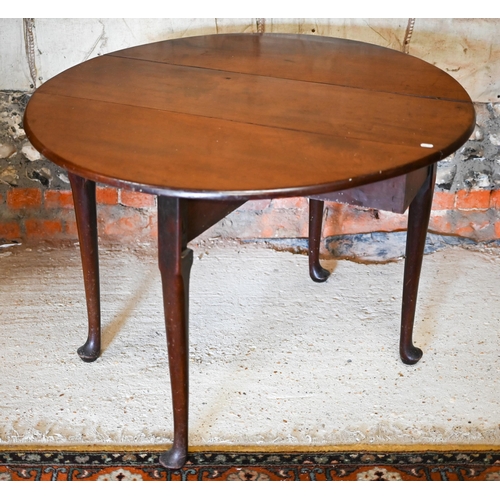 130 - A Georgian mahogany oval drop-leaf supper table raised on turned gatelegs, terminated by pad feet, 1... 