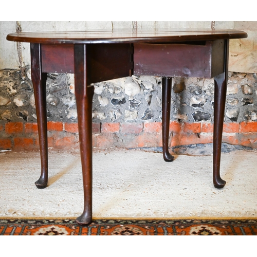 130 - A Georgian mahogany oval drop-leaf supper table raised on turned gatelegs, terminated by pad feet, 1... 