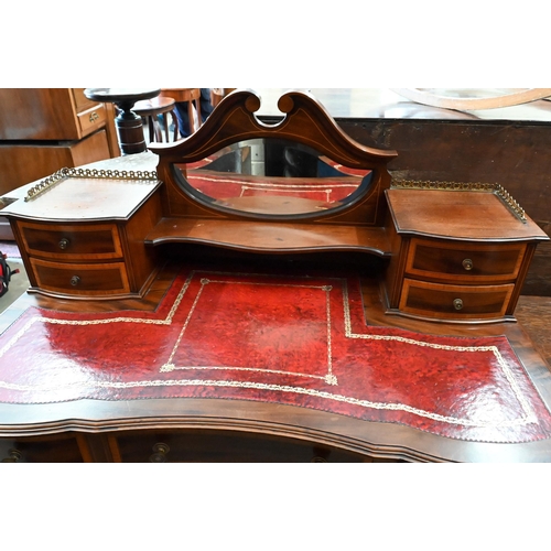 132 - An Edwardian mahogany crossbanded writing desk with tooled red leather top, bevelled mirror and eigh... 