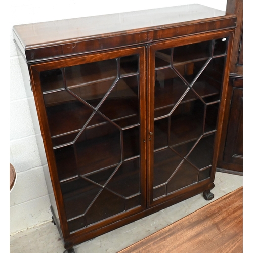 137 - A mahogany bookcase with astragal glazed doors enclosing adjustable shelves on ball and claw feet, 1... 