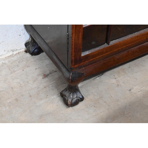 137 - A mahogany bookcase with astragal glazed doors enclosing adjustable shelves on ball and claw feet, 1... 