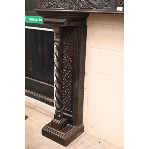 142 - A Victorian carved oak fire surround dated '1893'. with barley twist pillars, 188 x 40 x 150 cm over... 