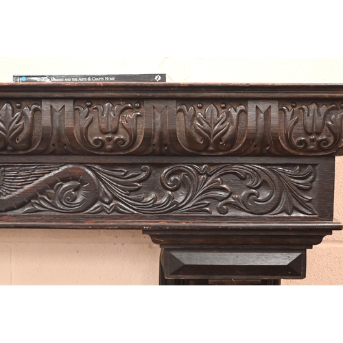 142 - A Victorian carved oak fire surround dated '1893'. with barley twist pillars, 188 x 40 x 150 cm over... 