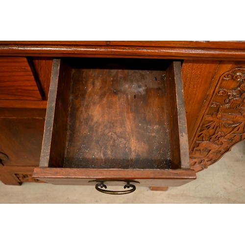 151 - A Chinese elm and brass mounted altar-top cabinet with two drawers and cupboards, decoratively carve... 