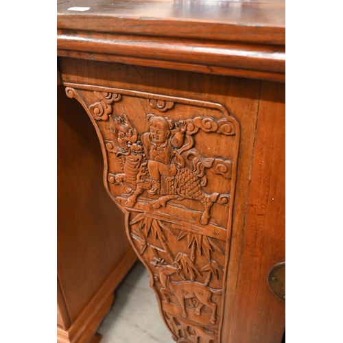 151 - A Chinese elm and brass mounted altar-top cabinet with two drawers and cupboards, decoratively carve... 