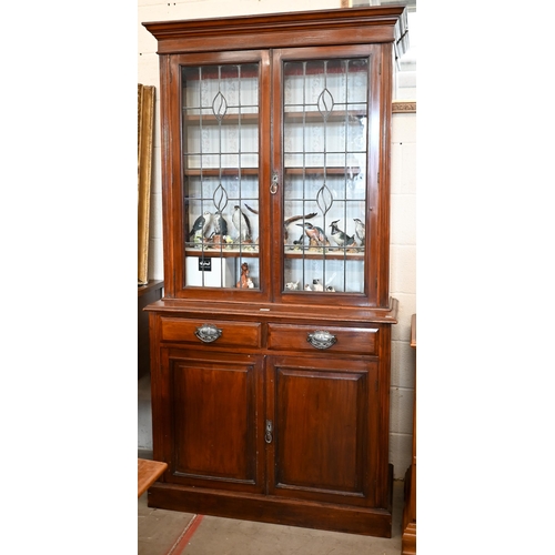 153 - An Edwardian mahogany chiffonier bookcase with leaded glazed doors over two drawers and panelled cup... 