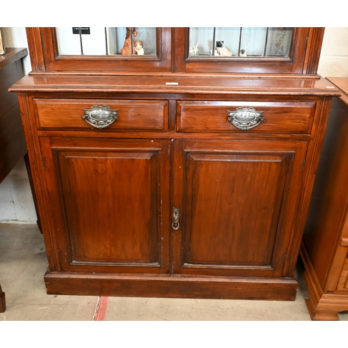 153 - An Edwardian mahogany chiffonier bookcase with leaded glazed doors over two drawers and panelled cup... 