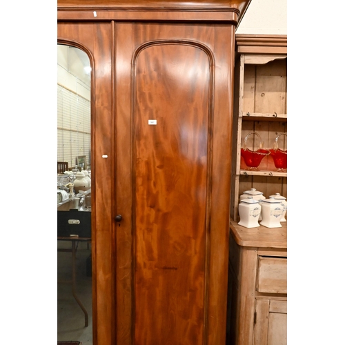 162 - A Victorian mahogany wardrobe with mirrored and panelled full length doors enclosing hanging rails a... 