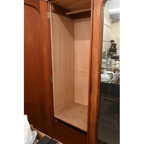 162 - A Victorian mahogany wardrobe with mirrored and panelled full length doors enclosing hanging rails a... 