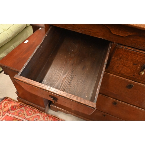 167 - An 18th century oak chest of three short over three long graduating drawers on shaped bracket feet, ... 