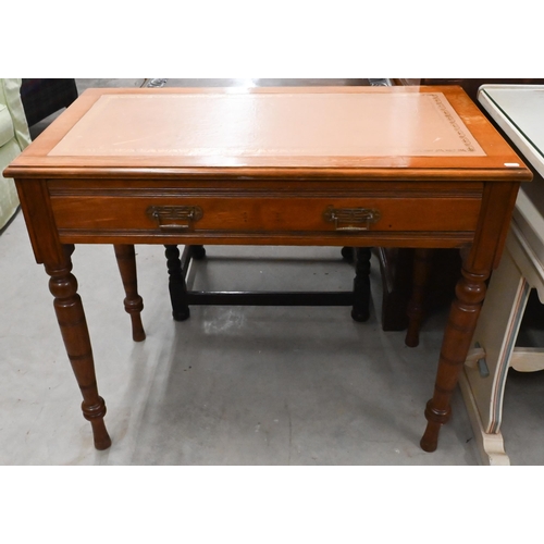 168 - # An Edwardian writing table with gilt tooled tan leather top and frieze drawer raised on turned sup... 