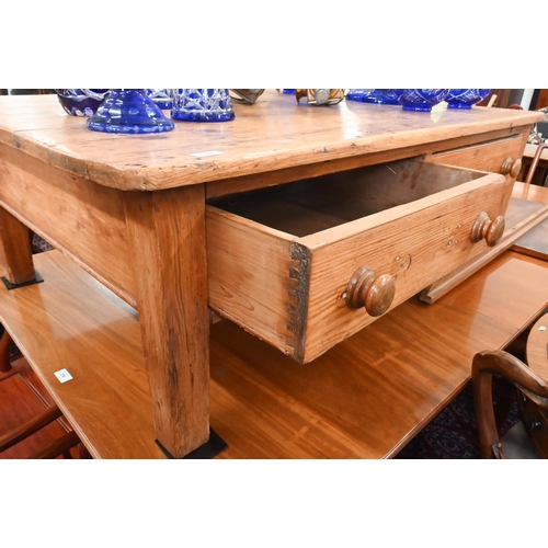 180 - A rustic waxed pine rectangular coffee table with two drawers, 138 x 86 x 45 cm