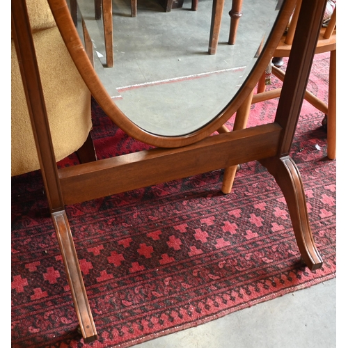 184 - A mahogany framed cheval mirror with bevelled oval plate and brass casters, 150 x 60 cm