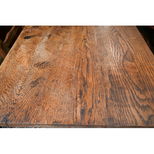 188 - An antique provincial refectory dining table on twin trestle supports united by jointed stretcher, 2... 