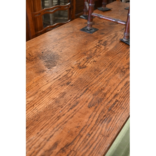 188 - An antique provincial refectory dining table on twin trestle supports united by jointed stretcher, 2... 