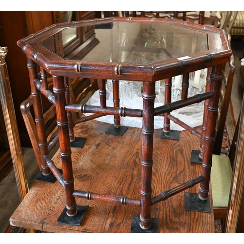 189 - A pair of simulated bamboo stained hardwood octagonal side/coffee tables with inset glass top, 65 cm... 