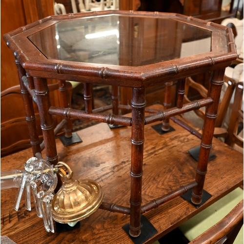 189 - A pair of simulated bamboo stained hardwood octagonal side/coffee tables with inset glass top, 65 cm... 