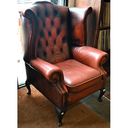 192 - A Georgian style wingback armchair, buttoned and studded leather upholstery and mahogany cabriole tr... 