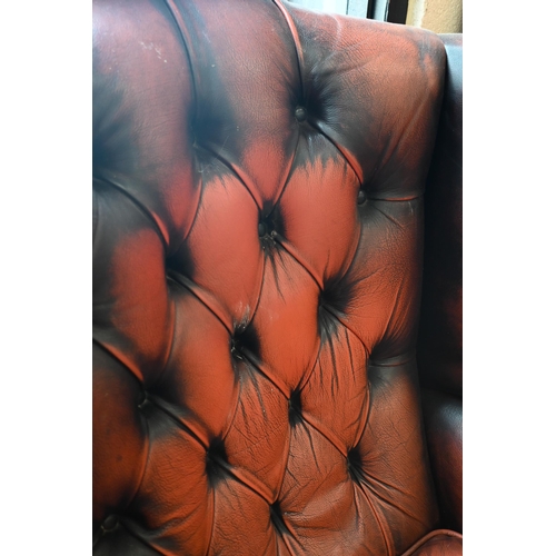 192 - A Georgian style wingback armchair, buttoned and studded leather upholstery and mahogany cabriole tr... 