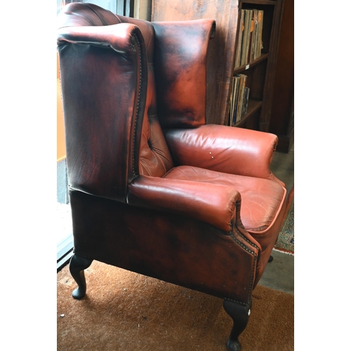 192 - A Georgian style wingback armchair, buttoned and studded leather upholstery and mahogany cabriole tr... 