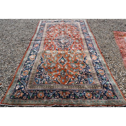 195 - A Persian Kelleigh carpet, of floral design on red ground, the blue border with repeating palmettes,... 